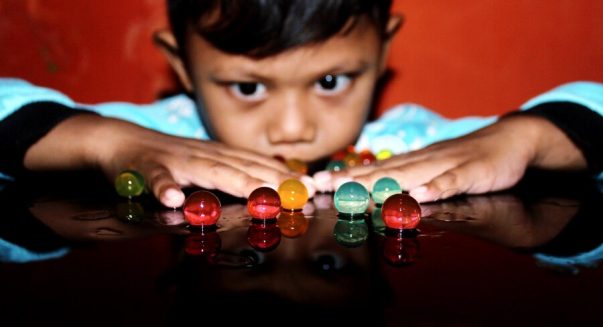 close-up-boy-looking-marbles-table_1048944-28239401.jpg