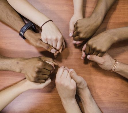 people-holding-hands-table-scaled.jpg
